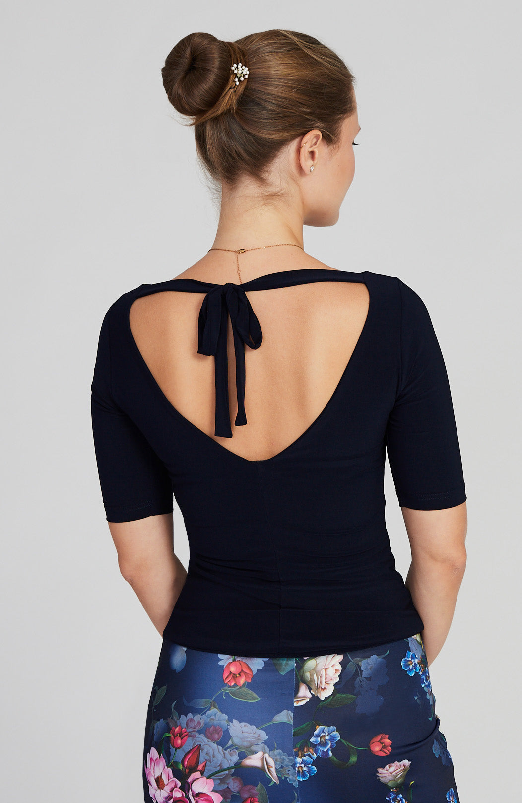 navy blue top with back cutout and bow